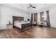 Spacious main bedroom with hardwood floors, recessed lighting, and large windows with decorative curtains at 9013 S 15Th Way, Phoenix, AZ 85042