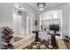 Bright home office with a modern desk, ornate light fixtures, and built-in shelving at 9013 S 15Th Way, Phoenix, AZ 85042