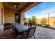 Covered patio with a large outdoor dining table and chairs, perfect for entertaining at 9013 S 15Th Way, Phoenix, AZ 85042