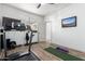 This workout room provides equipment for fitness and a spacious floor for exercise at 9013 S 15Th Way, Phoenix, AZ 85042