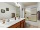 Bathroom features a double sink vanity and shower-tub combo at 9751 E Impala Ave, Mesa, AZ 85209