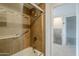 Bathroom shower with glass door and tiled walls at 10432 N 7Th Pl # 1, Phoenix, AZ 85020