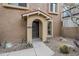 Inviting entryway with arched portico, desert landscaping, and a secure screen door at 10432 N 7Th Pl # 1, Phoenix, AZ 85020