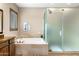 Bright bathroom featuring a soaking tub, walk-in shower, and tile surround at 10902 N 138Th Pl, Scottsdale, AZ 85259