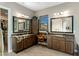Spacious primary bathroom with dual sinks, granite countertops, wood cabinets, and views at 10902 N 138Th Pl, Scottsdale, AZ 85259