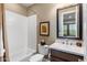 Bright bathroom with white tile, large mirror, and a shower/tub combination at 10902 N 138Th Pl, Scottsdale, AZ 85259