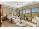 Bright and airy bedroom with a four-poster bed, sitting area, and views from shuttered windows at 10902 N 138Th Pl, Scottsdale, AZ 85259