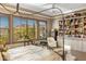 Bright bedroom featuring a four-poster bed, window views, and a charming teddy bear collection at 10902 N 138Th Pl, Scottsdale, AZ 85259