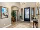 Inviting foyer with tile floors, decorative rug, and a view into the living space at 10902 N 138Th Pl, Scottsdale, AZ 85259