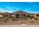Beautiful brick home with a tile roof and meticulously maintained desert landscaping in front at 10902 N 138Th Pl, Scottsdale, AZ 85259