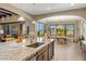 Open-concept kitchen with a granite island and a dining area with backyard views at 10902 N 138Th Pl, Scottsdale, AZ 85259