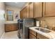 Well-equipped laundry room with modern washer and dryer units and ample cabinet space at 10902 N 138Th Pl, Scottsdale, AZ 85259