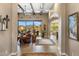 Open-concept living room with beamed ceilings, large windows, and elegant decor at 10902 N 138Th Pl, Scottsdale, AZ 85259