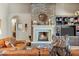 Living room featuring a stone fireplace and mantel, as well as built-in storage at 10902 N 138Th Pl, Scottsdale, AZ 85259