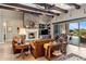 Cozy living room with a stone fireplace, comfortable leather furniture, and a sliding glass door at 10902 N 138Th Pl, Scottsdale, AZ 85259