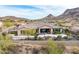 View of the rear of the home featuring mature landscaping, patio and mountain views at 10902 N 138Th Pl, Scottsdale, AZ 85259