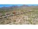 Aerial view of a desert community showcasing desert landscaping, pools, and a nearby walking trail at 10999 E Acoma Dr, Scottsdale, AZ 85255