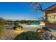 Tranquil backyard featuring a custom pool, desert landscaping, and picturesque mountain views at 10999 E Acoma Dr, Scottsdale, AZ 85255