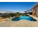Backyard pool featuring desert landscaping, an outdoor bar, and picturesque mountain views at 10999 E Acoma Dr, Scottsdale, AZ 85255
