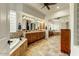 A bathroom with a double sink vanity, bath tub, and a large glass mirror at 10999 E Acoma Dr, Scottsdale, AZ 85255
