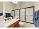 Bright bathroom featuring a sliding glass door shower and vanity with sink at 10999 E Acoma Dr, Scottsdale, AZ 85255