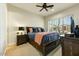 Cozy bedroom with wooden furniture, natural light, and ceiling fan at 10999 E Acoma Dr, Scottsdale, AZ 85255