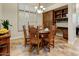 Charming dining area featuring a round wooden table and shuttered windows for natural light at 10999 E Acoma Dr, Scottsdale, AZ 85255