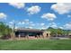Beautiful single-story home with manicured lawn and desert landscaping on a sunny day at 10999 E Acoma Dr, Scottsdale, AZ 85255