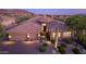 Stunning desert home with a tile roof, 3-car garage, and professionaly manicured desert landscaping at 10999 E Acoma Dr, Scottsdale, AZ 85255