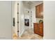 Hallway with access to the bedroom with wood cabinets and tile floor at 10999 E Acoma Dr, Scottsdale, AZ 85255
