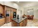 Well-equipped kitchen with stainless steel appliances, granite island, and breakfast nook at 10999 E Acoma Dr, Scottsdale, AZ 85255