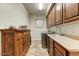 Functional laundry room with ample cabinet storage, sink, and modern washer/dryer at 10999 E Acoma Dr, Scottsdale, AZ 85255