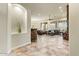Open living room with tile flooring, stone fireplace, and shuttered windows for abundant natural light at 10999 E Acoma Dr, Scottsdale, AZ 85255