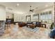 Spacious living area featuring tile floors, leather sofas, and an adjacent billiards room for entertaining at 10999 E Acoma Dr, Scottsdale, AZ 85255