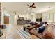 Expansive living room with tile flooring, bar, pool table, and natural light from shuttered windows at 10999 E Acoma Dr, Scottsdale, AZ 85255