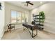 Well-lit office space with carpet floor and a stylish black desk at 10999 E Acoma Dr, Scottsdale, AZ 85255