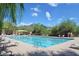 Community pool with lane dividers, lounge chairs, and desert mountain views at 10999 E Acoma Dr, Scottsdale, AZ 85255