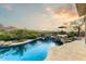 Sparkling pool featuring a waterfall, spa, and beautifully landscaped surroundings at 10999 E Acoma Dr, Scottsdale, AZ 85255
