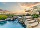 Backyard pool area with a custom waterfall, integrated spa, and desert landscaping at 10999 E Acoma Dr, Scottsdale, AZ 85255