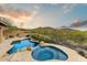 Relaxing backyard oasis with a custom pool, spa, and lush desert landscaping at 10999 E Acoma Dr, Scottsdale, AZ 85255