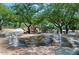 Splashpad area surrounded by trees and a walking path at 10999 E Acoma Dr, Scottsdale, AZ 85255