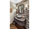 Stylish bathroom with stone accent wall, vessel sink, and decorative lighting fixtures at 11021 N 74Th St, Scottsdale, AZ 85260