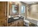 Stylish bathroom with a granite countertop and tiled shower at 11021 N 74Th St, Scottsdale, AZ 85260