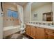 Well-lit bathroom featuring a tub, window, and marble vanity top at 11021 N 74Th St, Scottsdale, AZ 85260