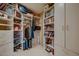 Walk-in closet with ample shelving and storage space for clothes and luggage at 11021 N 74Th St, Scottsdale, AZ 85260