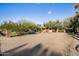Expansive desert landscaped front yard with stone pillar and entry gate at 11021 N 74Th St, Scottsdale, AZ 85260