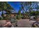 A desert oasis with a tile roofed home surrounded by cacti, mature trees and desert landscaping at 11021 N 74Th St, Scottsdale, AZ 85260