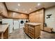 Spacious laundry room with ample cabinetry, counter space, and dual washer/dryer units at 11021 N 74Th St, Scottsdale, AZ 85260