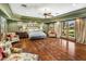 Bright main bedroom with hardwood floors, sitting area, and French door access to the outdoors at 11021 N 74Th St, Scottsdale, AZ 85260