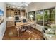 Dedicated home office featuring built-in bookshelves, a large window, and a vintage desk at 11021 N 74Th St, Scottsdale, AZ 85260